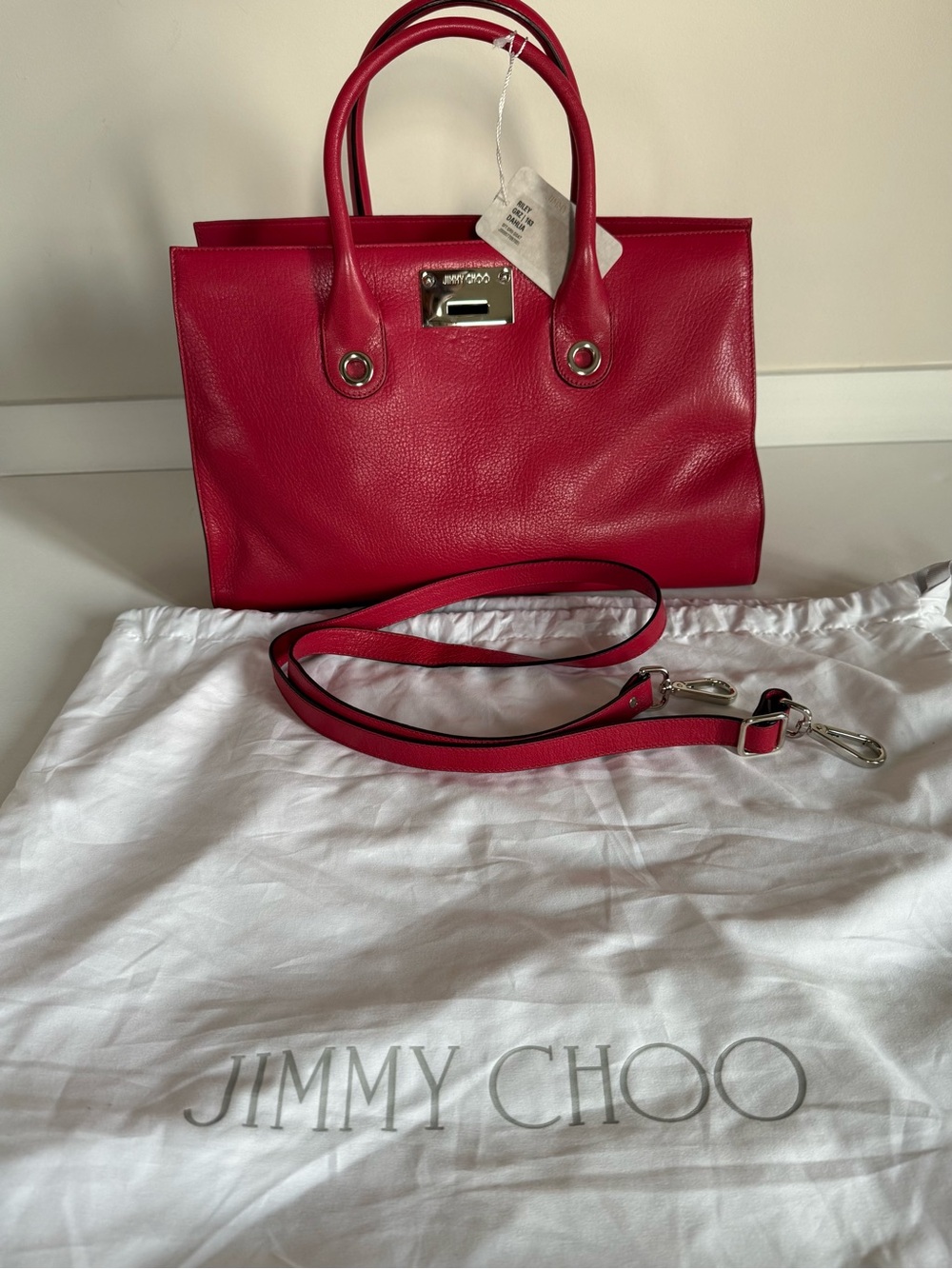 New with tag, Jimmy Choo Red Leather Purse with dust bag and shoulder strap.